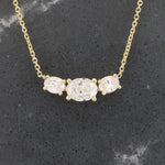 Load image into Gallery viewer, Gold necklace featuring three oval clear glass stones in a sleek, elegant design. Perfect for everyday wear.