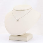 Load image into Gallery viewer, Sterling silver necklace with a sparkling cubic zirconia pendant on a display bust. Elegant and modern design.