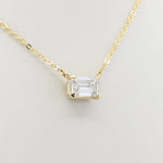 Load image into Gallery viewer, Elegant gold chain necklace featuring a clear emerald-cut cubic zirconia pendant. Perfect for everyday wear or special occasions.