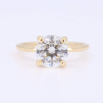 Load image into Gallery viewer, Gold engagement ring with a round, sparkling clear diamond in a classic four-prong setting.