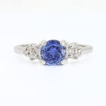 Load image into Gallery viewer, Sapphire and diamond ring in white gold, featuring a central blue sapphire surrounded by sparkling diamonds.
