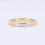 Load image into Gallery viewer, Elegant gold band ring featuring alternating baguette-cut and channel-set diamonds. Perfect for stacking or engagement.