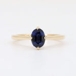Load image into Gallery viewer, Elegant gold ring featuring an oval-shaped blue sapphire. Perfect for engagement or special occasions.