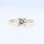 Load image into Gallery viewer, Gold engagement ring with a round diamond centerpiece and three smaller diamonds on a sleek band.
