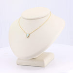 Load image into Gallery viewer, Gold necklace with teardrop opal pendant on a soft display stand. Elegant and timeless design.