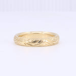 Load image into Gallery viewer, Elegant gold wave-patterned band ring, crafted in 14k yellow gold, perfect for everyday wear or special occasions.