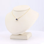 Load image into Gallery viewer, Gold necklace with a blue gemstone pendant on a display bust, perfect for elegant style and everyday wear.