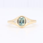 Load image into Gallery viewer, Gold ring featuring an oval green sapphire and two sparkling diamonds on each side. Stylish and elegant design.