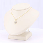 Load image into Gallery viewer, Gold chain necklace with a sparkling diamond pendant displayed on a beige jewelry bust.