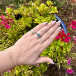 Load image into Gallery viewer, Elegant gold and blue gemstone rings on a hand, surrounded by vibrant pink flowers. Perfect for stylish jewelry lovers.