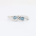 Load image into Gallery viewer, Sterling silver twisted ring featuring two tear-shaped aquamarine gemstones.