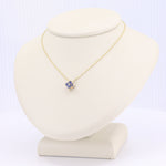 Load image into Gallery viewer, Medium sapphire quatrefoil pendant in yellow gold on an 18-inch chain.