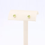 Load image into Gallery viewer, Green peridot stud earrings in yellow gold setting, classic and elegant design perfect for everyday wear.