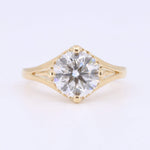 Load image into Gallery viewer, Gold solitaire engagement ring with a round diamond centerpiece and a delicate split shank design.