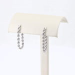 Load image into Gallery viewer, Sterling silver rope twist earrings, elegant design displayed on a soft cream-colored stand.