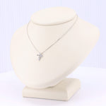 Load image into Gallery viewer, Silver cross pendant necklace adorned with sparkling cubic zirconia stones on a delicate chain.