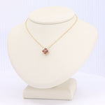 Load image into Gallery viewer, Gold floral pendant necklace with pink gemstones, elegant design perfect for casual or formal occasions.