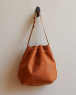 Load image into Gallery viewer, Tan Leather Tie Bucket Bag with Adjustable Strap and Yellow Hardware