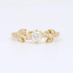 Load image into Gallery viewer, Vintage-inspired gold engagement ring with a central diamond and leaf accents, featuring shimmering smaller stones.