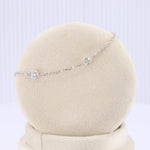 Load image into Gallery viewer, Silver diamond-accented bracelet on a beige velvet display, featuring a delicate chain design.