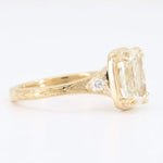 Load image into Gallery viewer, Vintage-style yellow gold ring with a large cushion-cut diamond and accent stones, featuring intricate engravings.