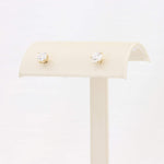 Load image into Gallery viewer, Gold stud earrings with sparkling clear cubic zirconia stones, elegant and timeless design. Perfect for any occasion.