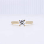 Load image into Gallery viewer, Gold solitaire engagement ring with a sparkling round crystal center. Elegant and timeless design.
