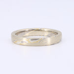 Load image into Gallery viewer, Men's stainless steel wedding band with unique damascus pattern, silver and gold tones, 7mm width, modern style.