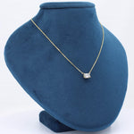 Load image into Gallery viewer, Gold chain necklace with a rectangular clear gemstone, displayed on a navy blue velvet bust.