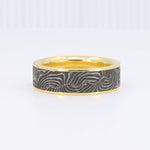 Load image into Gallery viewer, Gold and black damascus steel ring with a wavy pattern, modern design for men or women.