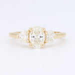 Load image into Gallery viewer, Elegant 14k yellow gold ring featuring a central oval diamond and two round diamonds on each side.