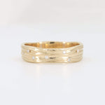 Load image into Gallery viewer, Gold textured band ring with sparkling white diamonds, featuring a modern wavy design.