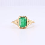 Load image into Gallery viewer, Emerald cut green emerald ring in yellow gold, featuring intricate vintage-style detailing.