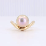 Load image into Gallery viewer, Gold wave ring featuring a large iridescent pink pearl for a modern, elegant look.
