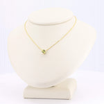 Load image into Gallery viewer, Elegant gold-toned necklace featuring a vibrant peridot gemstone pendant on a delicate chain. Perfect for any occasion.