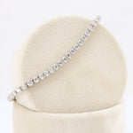 Load image into Gallery viewer, Elegant silver tennis bracelet featuring sparkling round-cut cubic zirconia stones in a classic design.