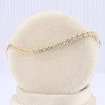 Load image into Gallery viewer, Gold-tone bracelet with sparkling clear cubic zirconia stones, featuring an elegant, slender design.
