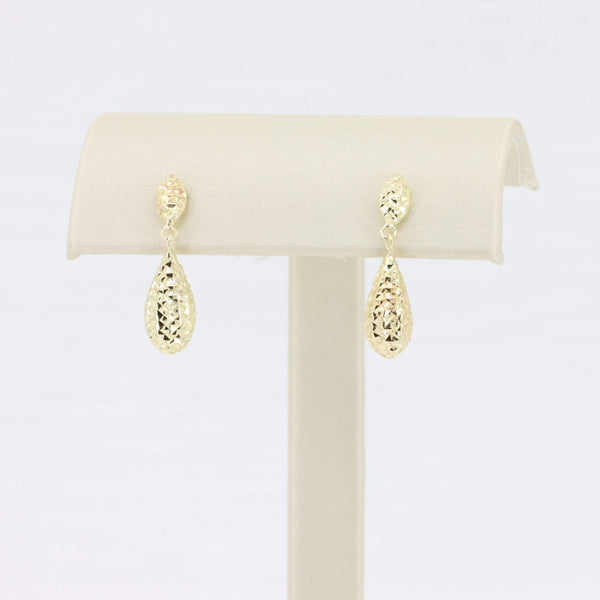Stylish gold teardrop earrings with a hammered finish, perfect for any elegant occasion.