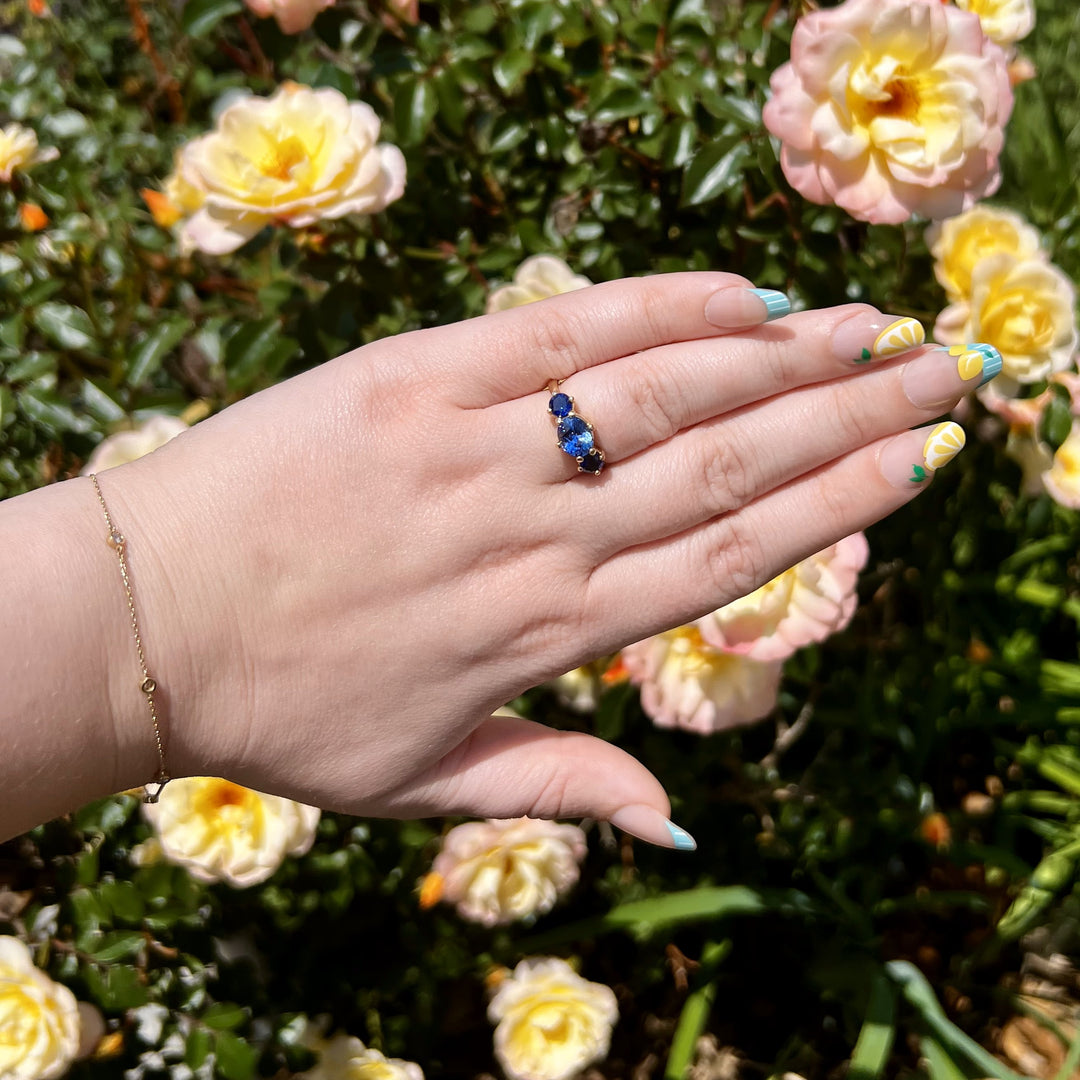 Three Stone Sapphire Ring with East West Set Oval Center set in Yellow Gold