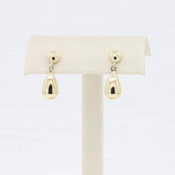 Gold teardrop earrings in polished metal, chic and elegant for any occasion.