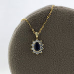 Load image into Gallery viewer, Oval Sapphire and Diamond Halo Necklace in Yellow Gold
