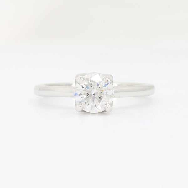 Sterling silver engagement ring with a round, brilliant cut diamond centerpiece, elegantly designed for timeless style.