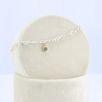 Load image into Gallery viewer, Silver Figaro Chain Bracelet w/ Montana Sapphire Charm in Yellow Gold
