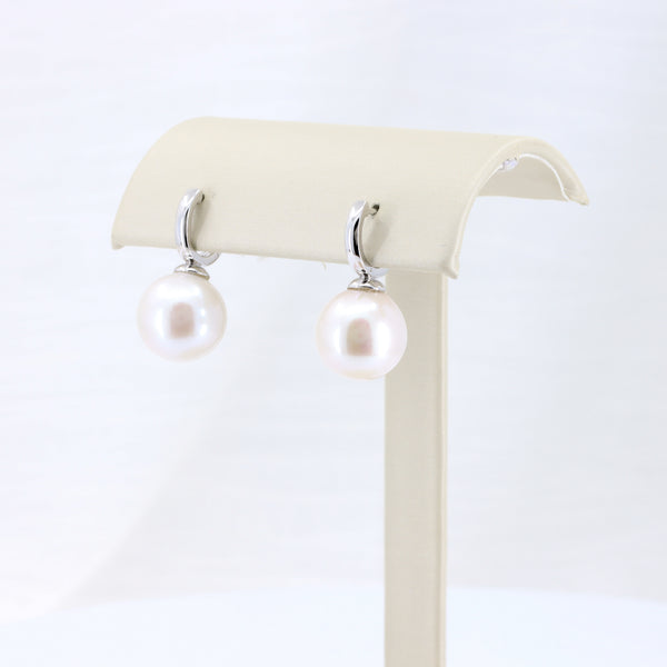 Elegant pearl drop earrings in white with silver-tone settings, perfect for any formal or casual occasion.