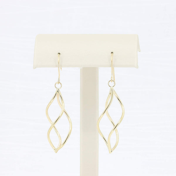 Gold swirl dangle earrings in a sleek design, perfect for modern elegance and everyday wear.