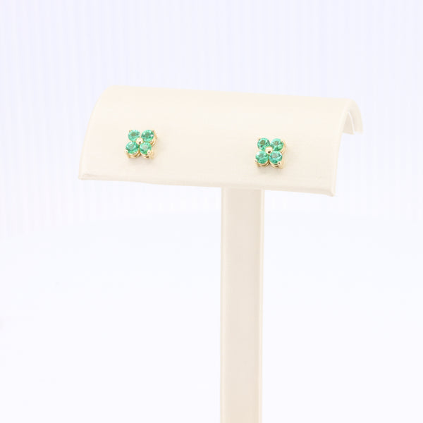 Emerald quatrefoil stud earrings in yellow gold by KIZER-CUMMINGS JEWELERS