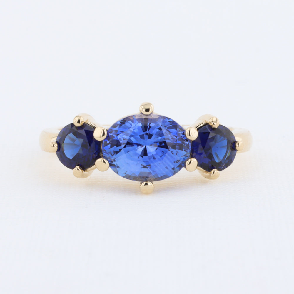 Three Stone Sapphire Ring with East West Set Oval Center set in Yellow Gold