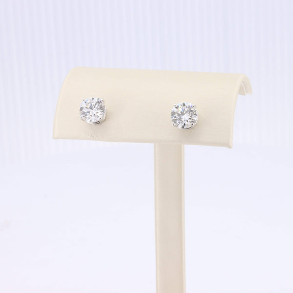 Sterling silver stud earrings with sparkling round clear cubic zirconia stones. Elegant and timeless design.