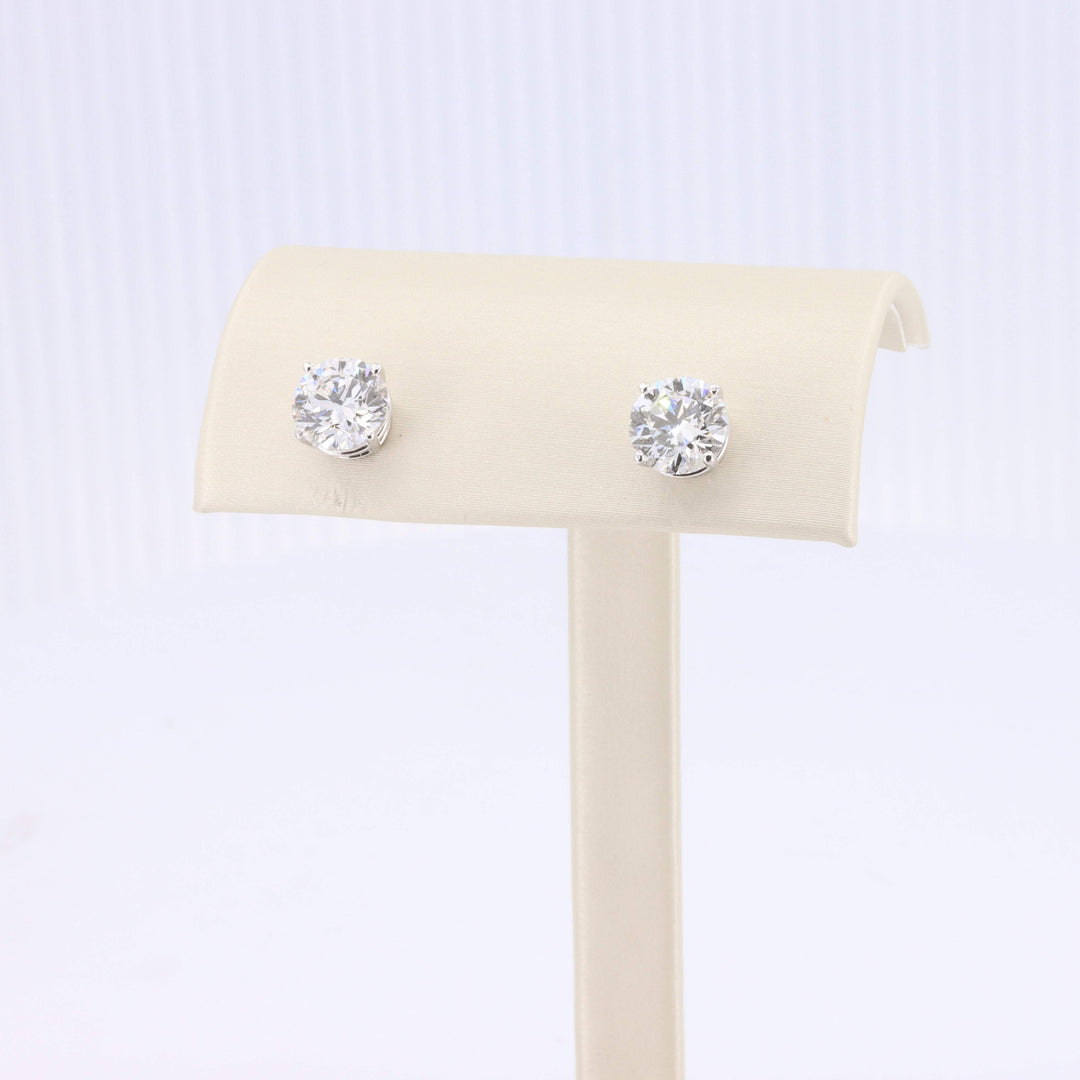 Sterling silver stud earrings with sparkling round clear cubic zirconia stones. Elegant and timeless design.