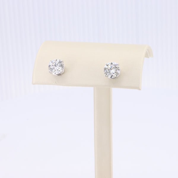 Sterling silver stud earrings featuring round, brilliant-cut clear cubic zirconia stones.